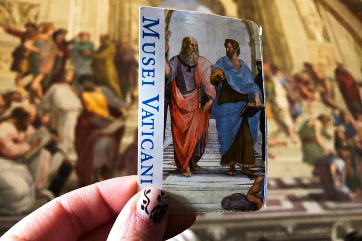 a person holding up a card with a picture of a painting