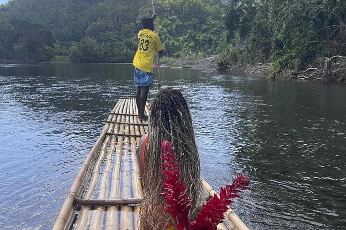 a man standing on the end of a raft on a river