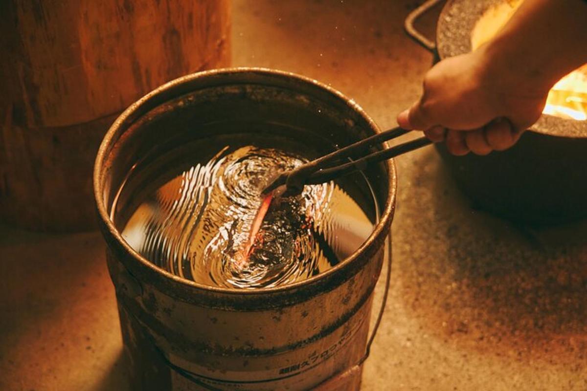 a person holding a pair of chopsticks in a bucket