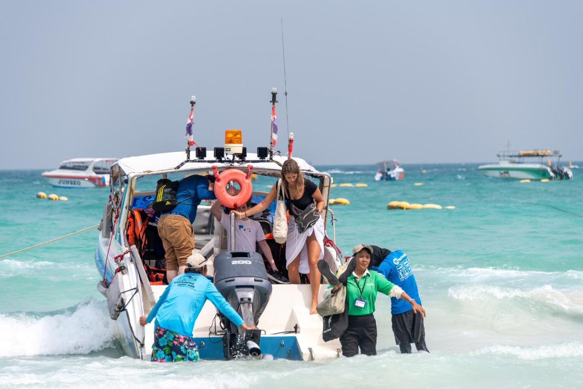 a group of people on a boat on the beach