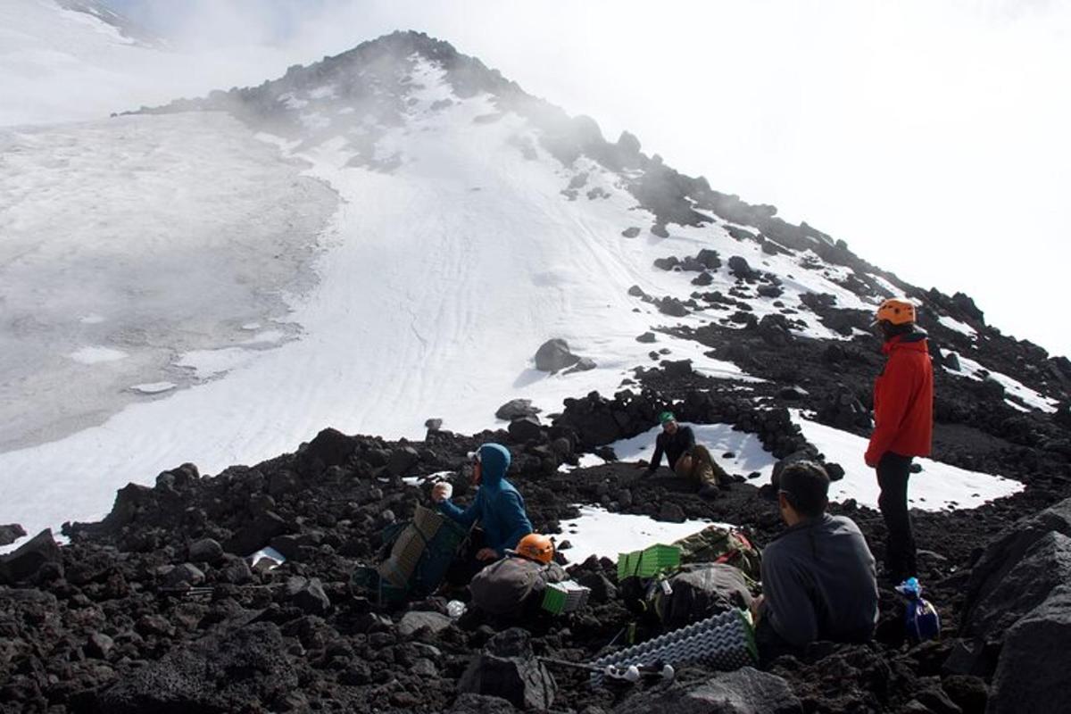 a group of people sitting on top of a mountain