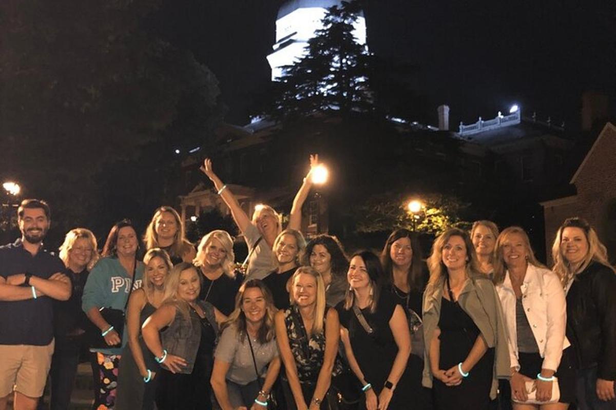 a group of people posing for a picture at night