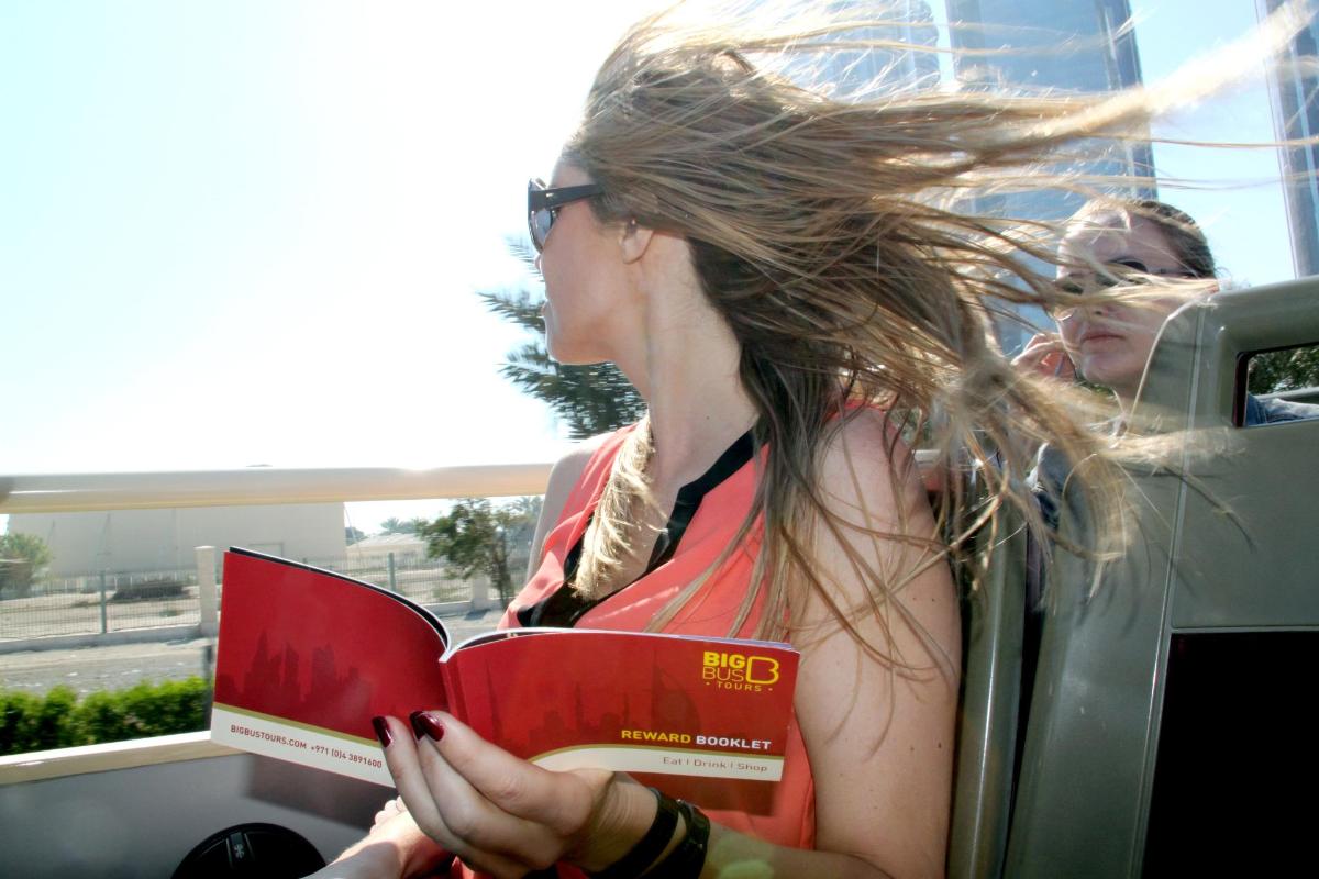 a woman reading a book while sitting in a car