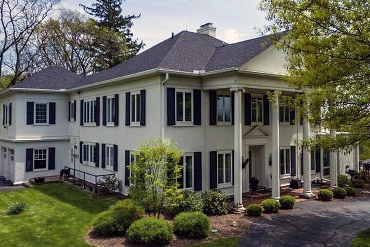 a large white house with black shutters