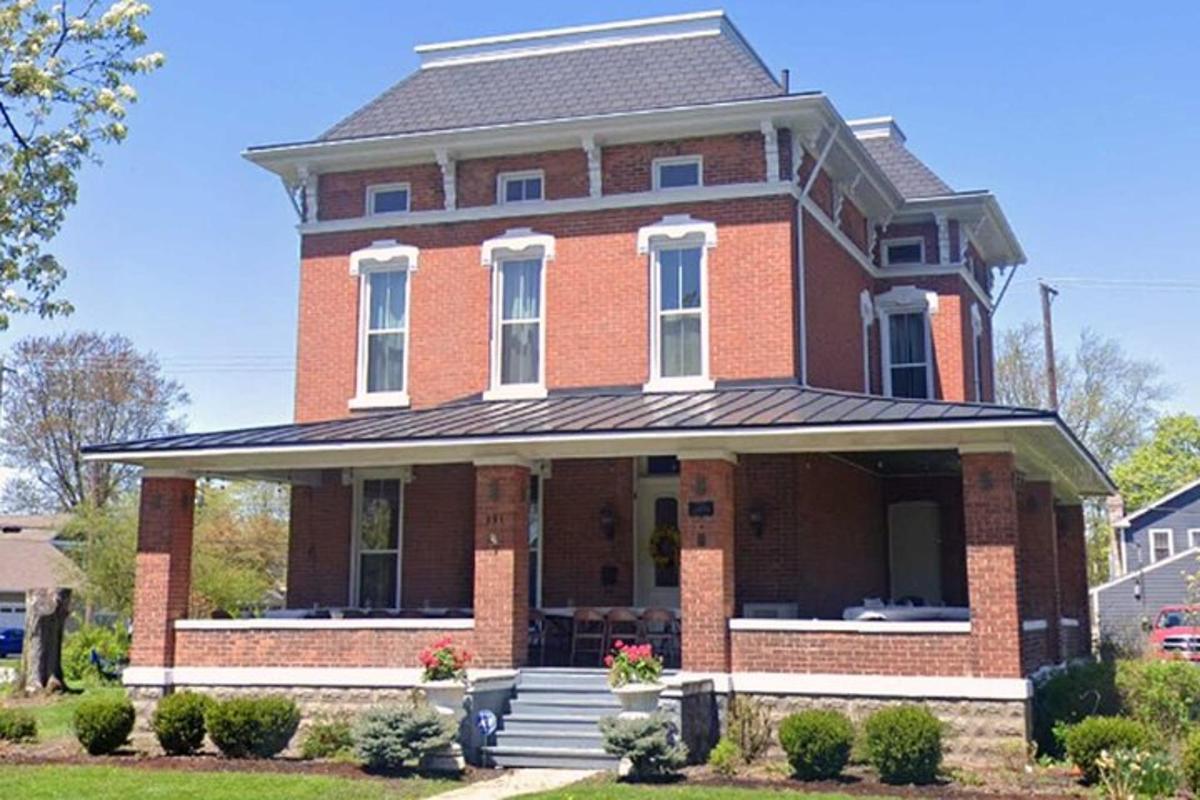 a large red brick house with a porch