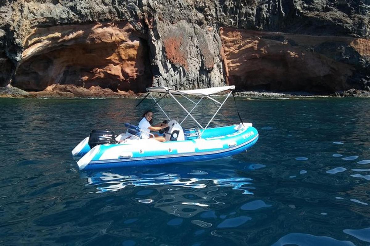 a man and a dog in a blue boat in the water