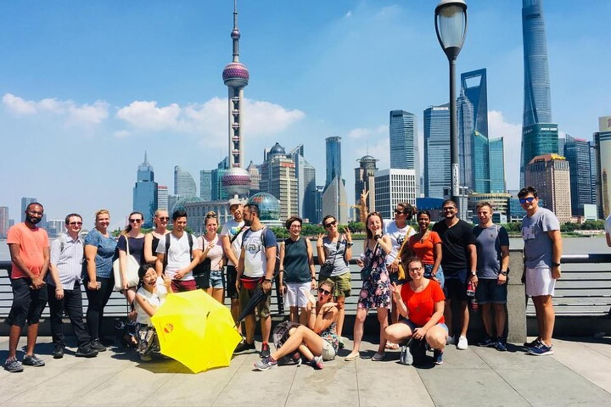 a group of people posing for a picture in front of a city
