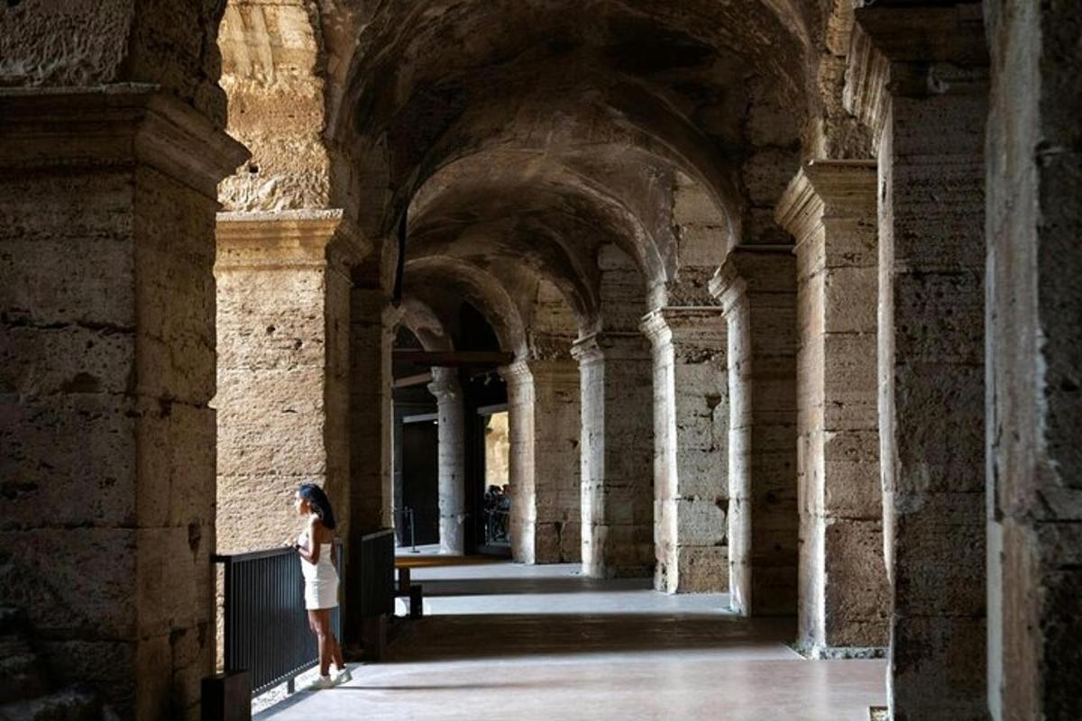 a woman is standing in a building with columns