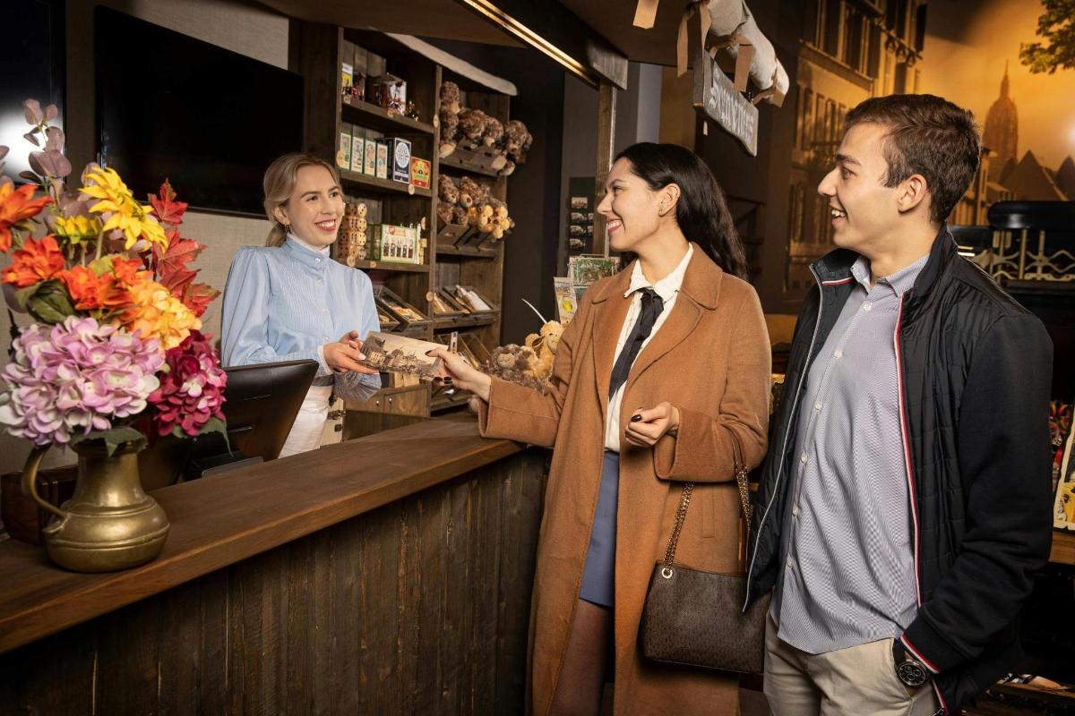 two people standing at a cash register