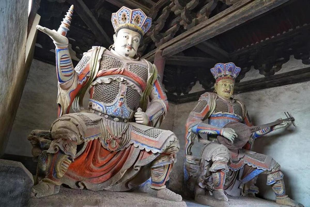 a statue of a man riding an elephant with a gun