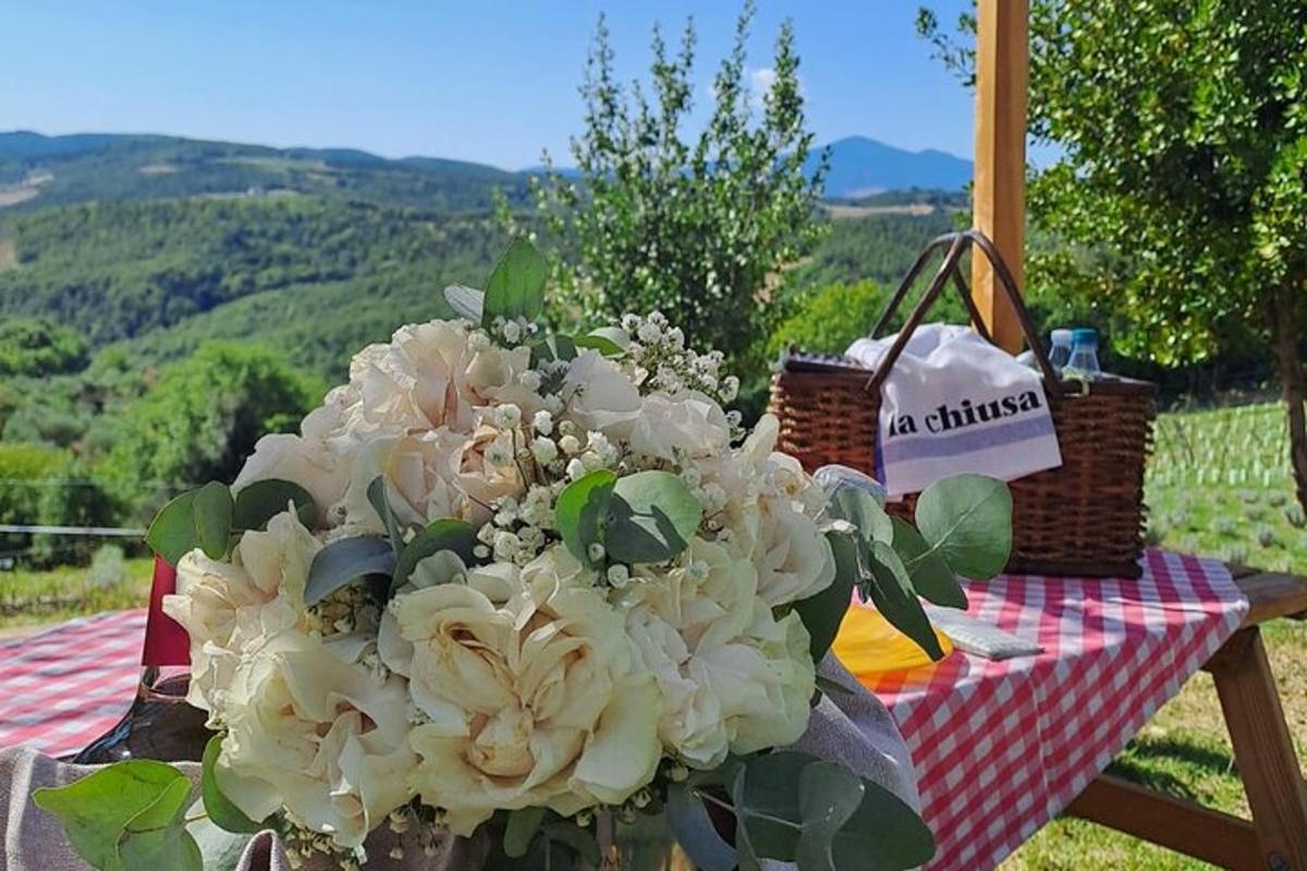 a vase of flowers sitting on a picnic table