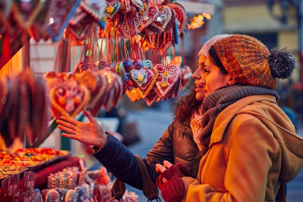 two women standing in a market looking at meat