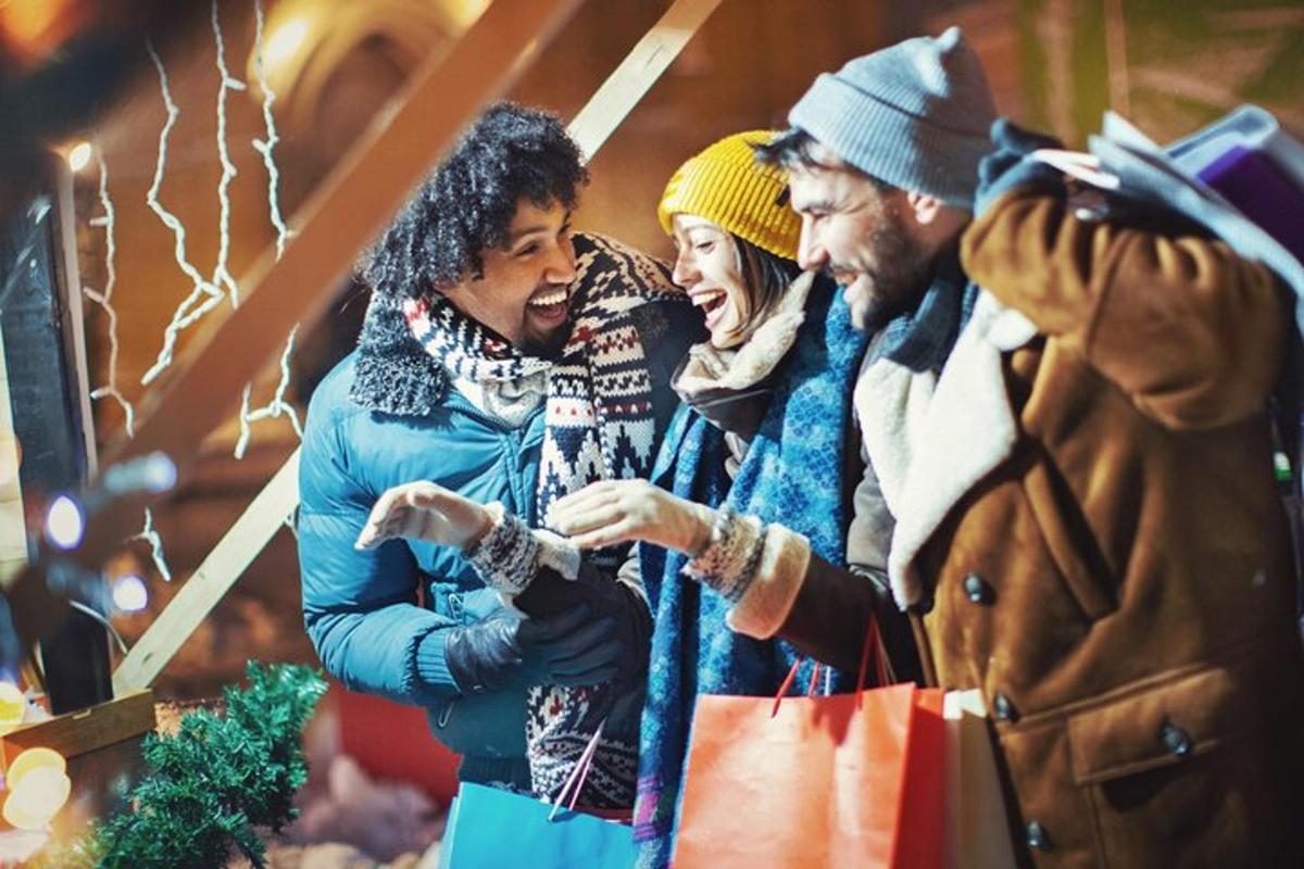 a group of three people looking at a shopping bag