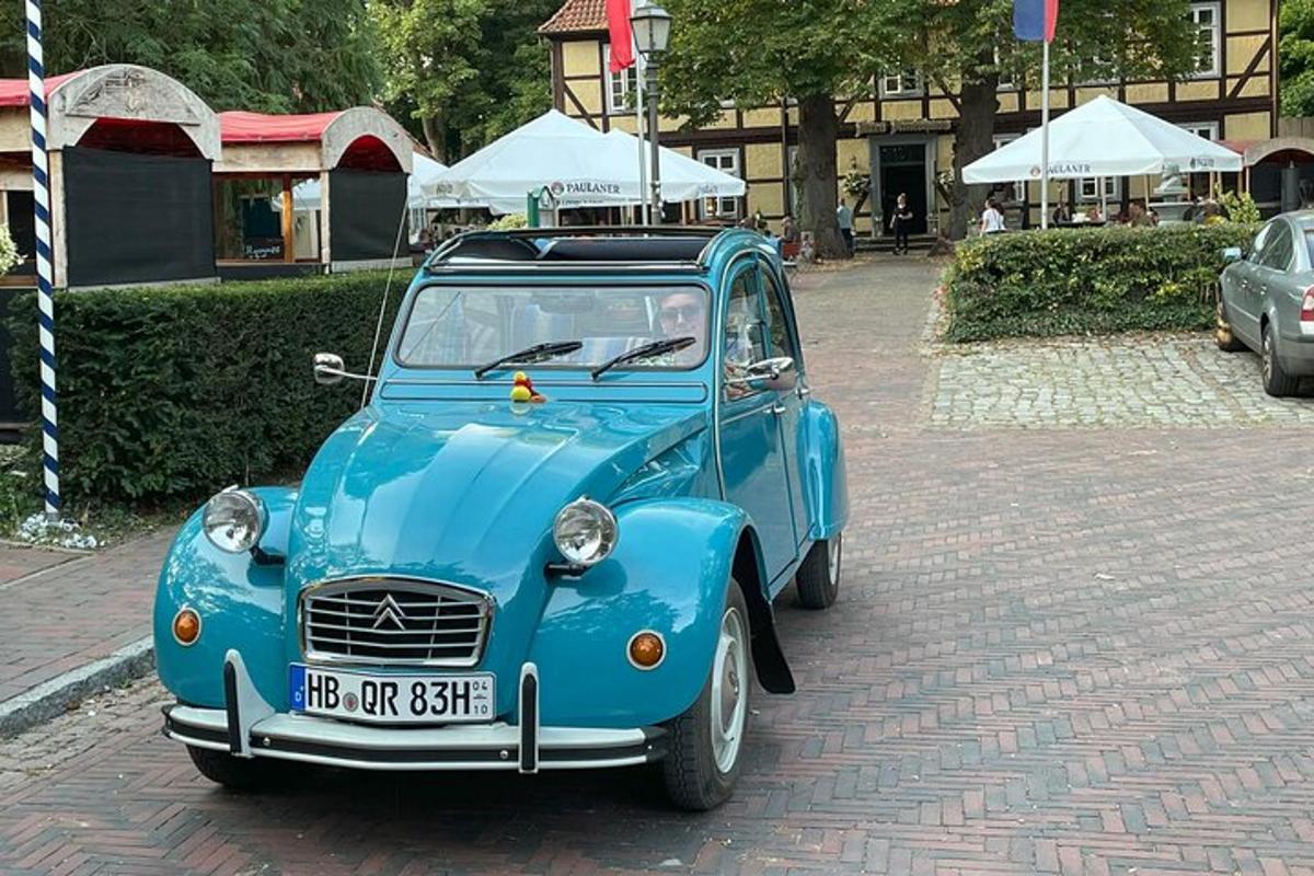 a blue car parked on a brick road