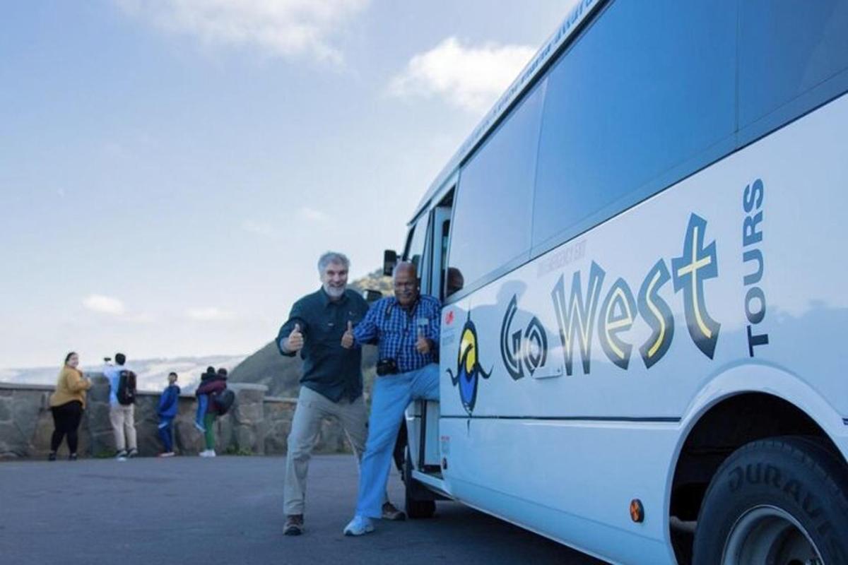 due uomini sono in piedi accanto a un autobus