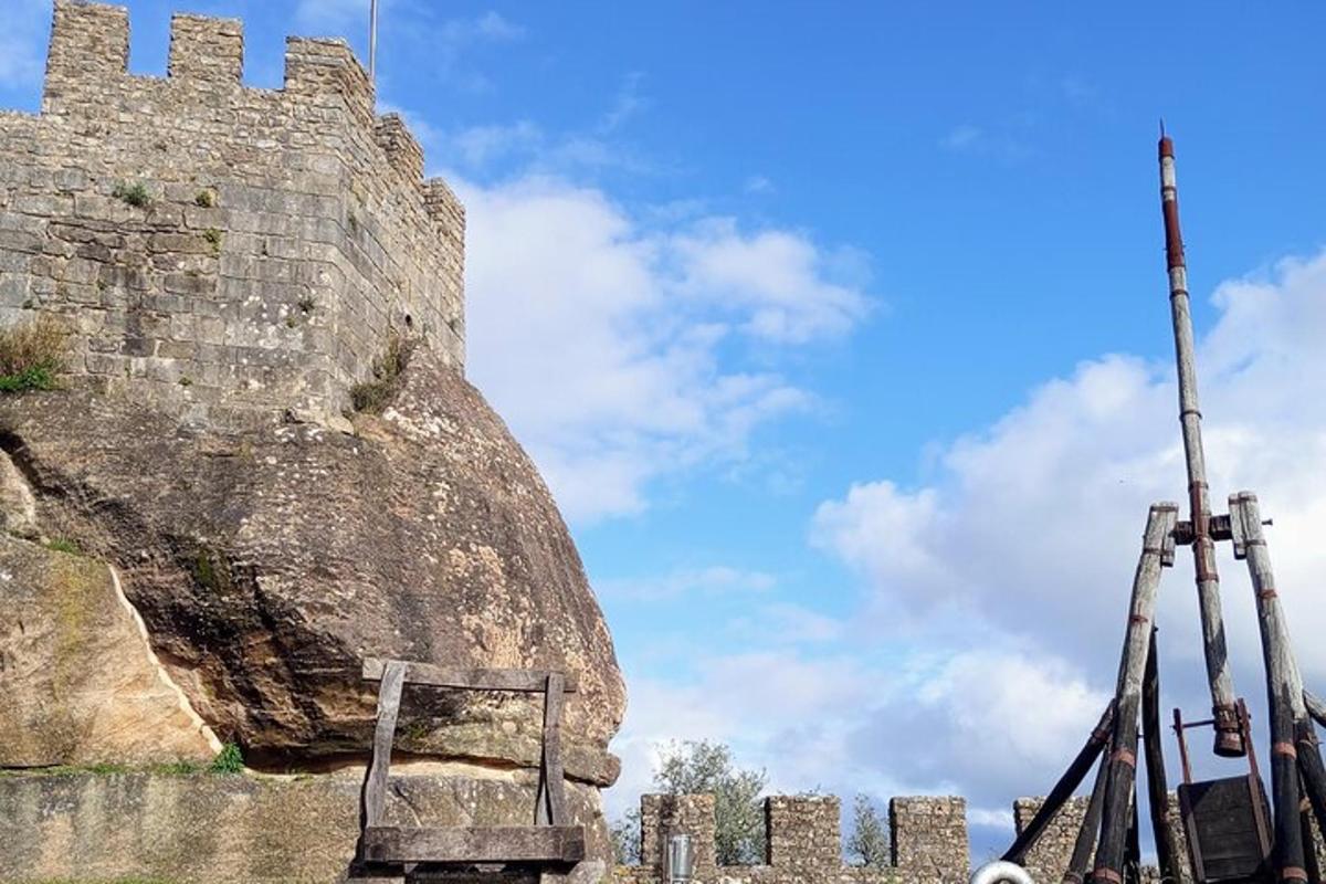 a castle with a wooden bench next to a rock