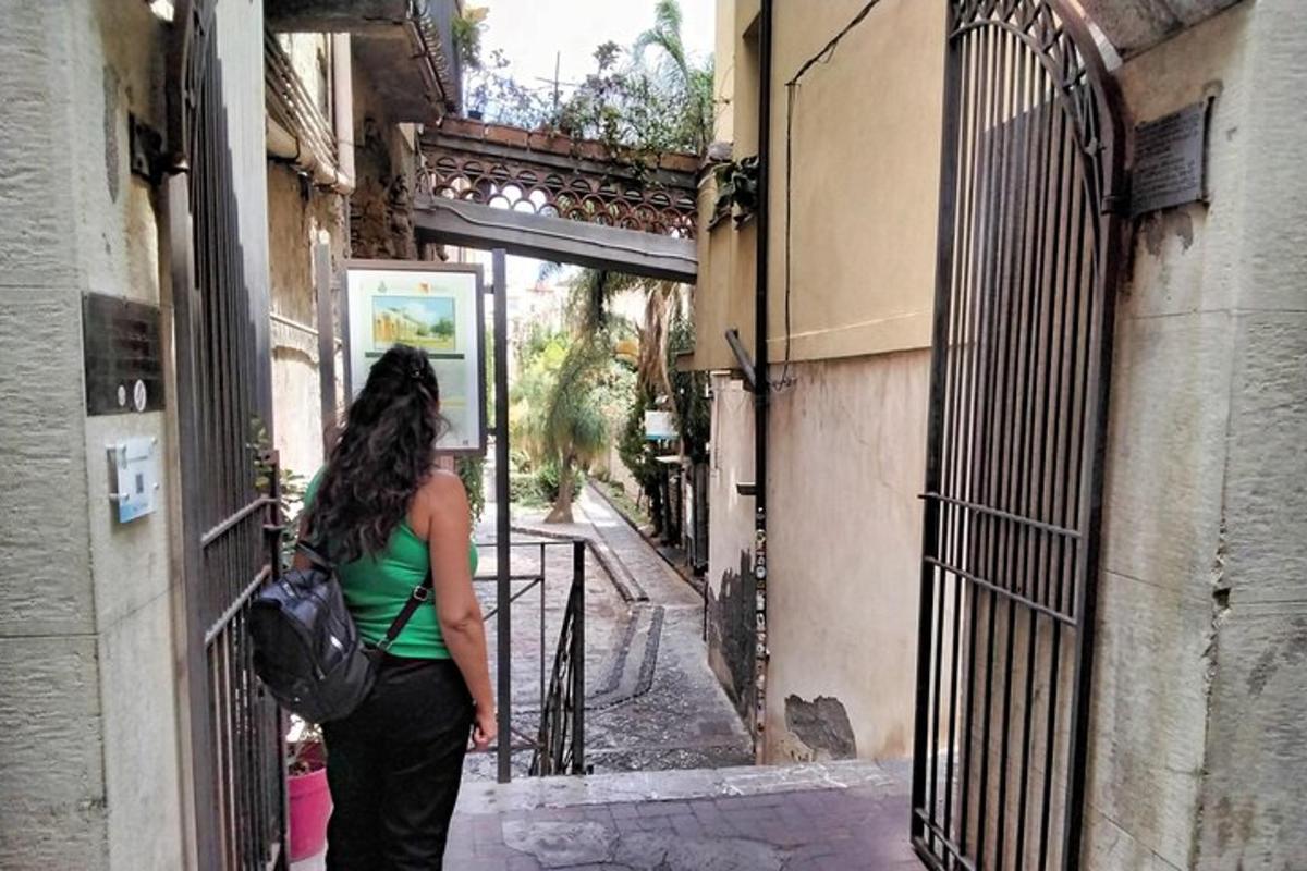 a woman standing in an alley looking out of a door