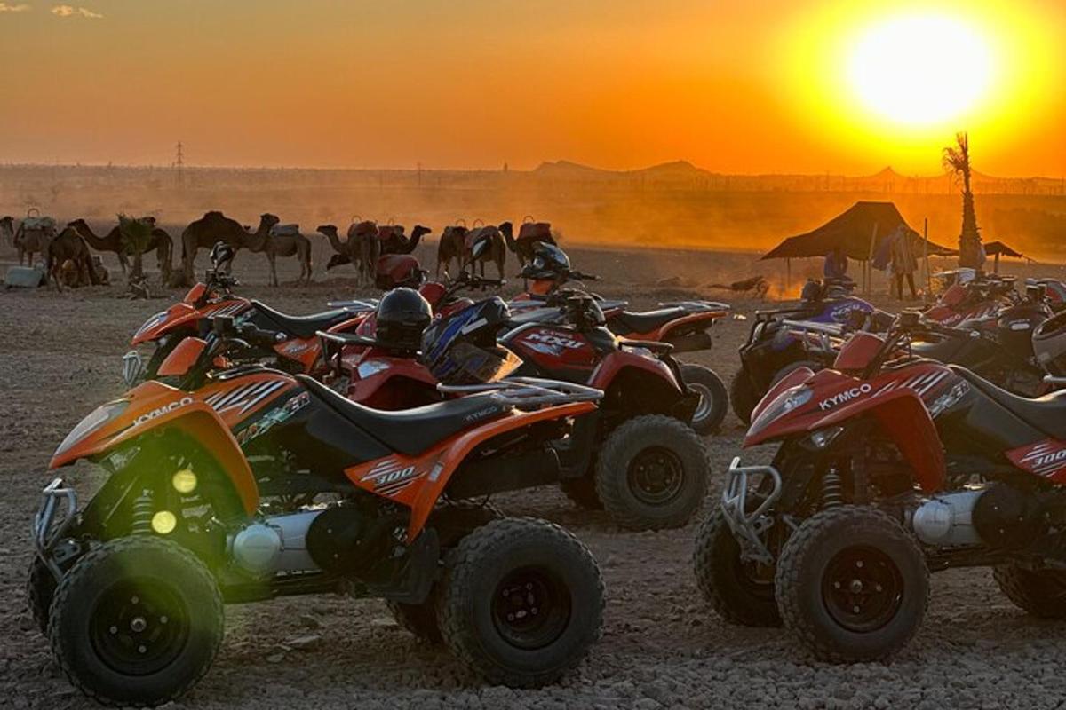 a group of atvs parked in the desert at sunset