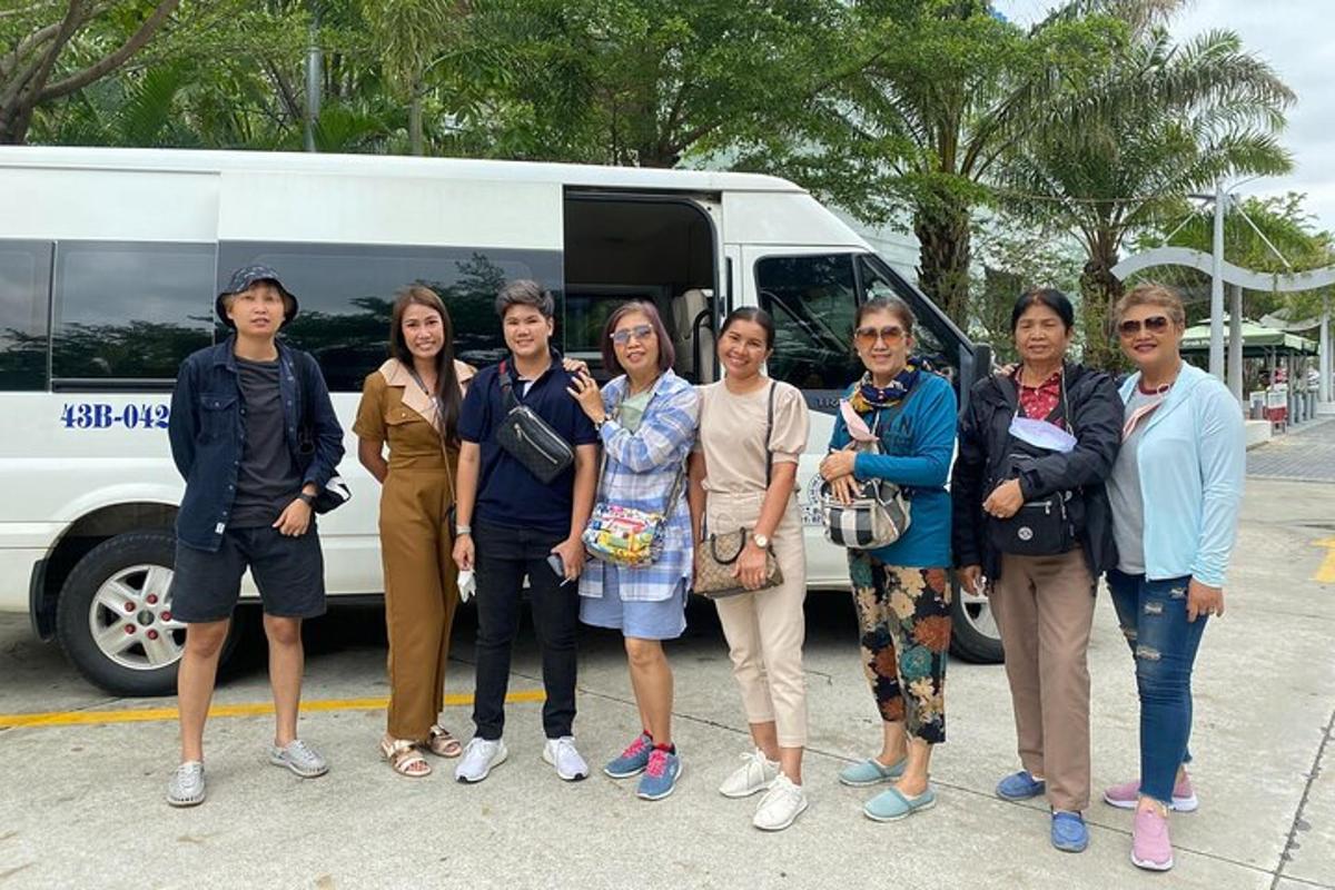 a group of people standing in front of a bus