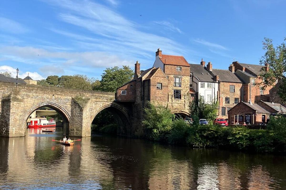 a boat in a river under a bridge