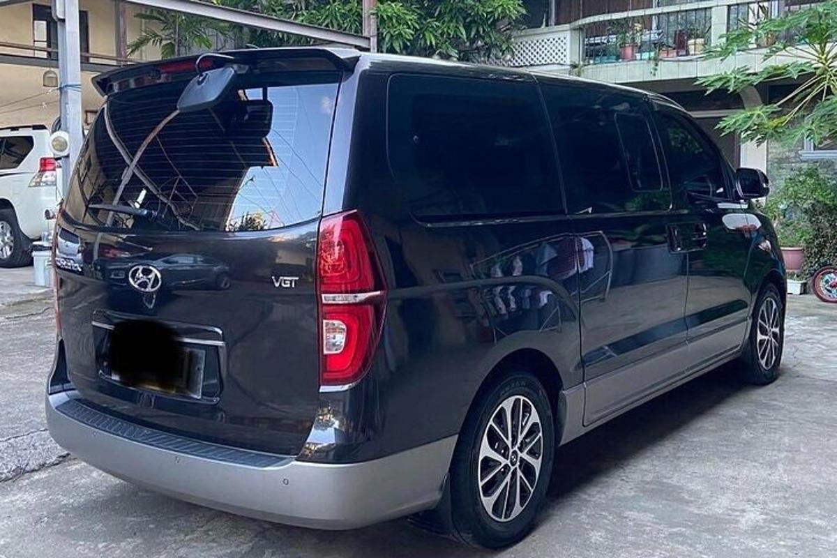 a black van with its back open with its trunk