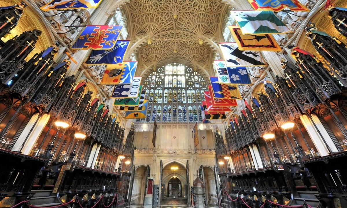 a church with flags hanging from the ceiling
