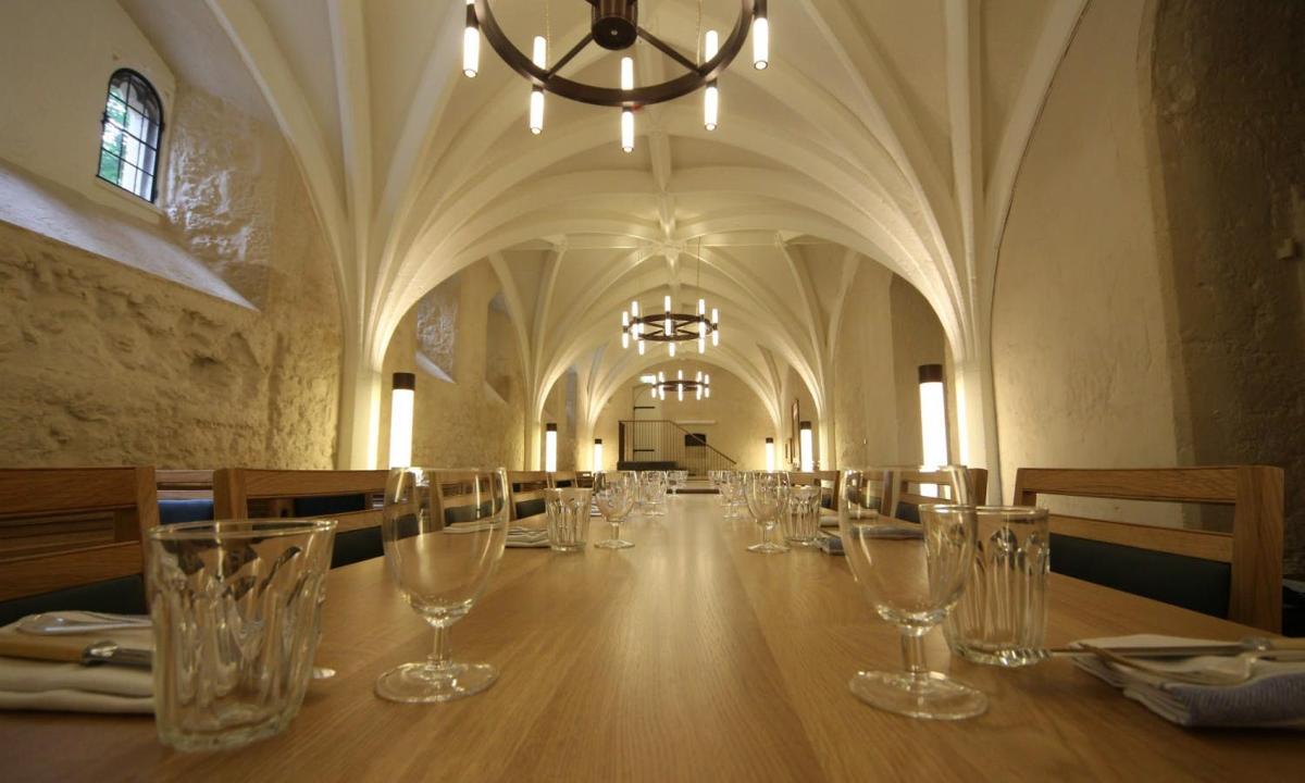 a long table in a large room with glasses on it