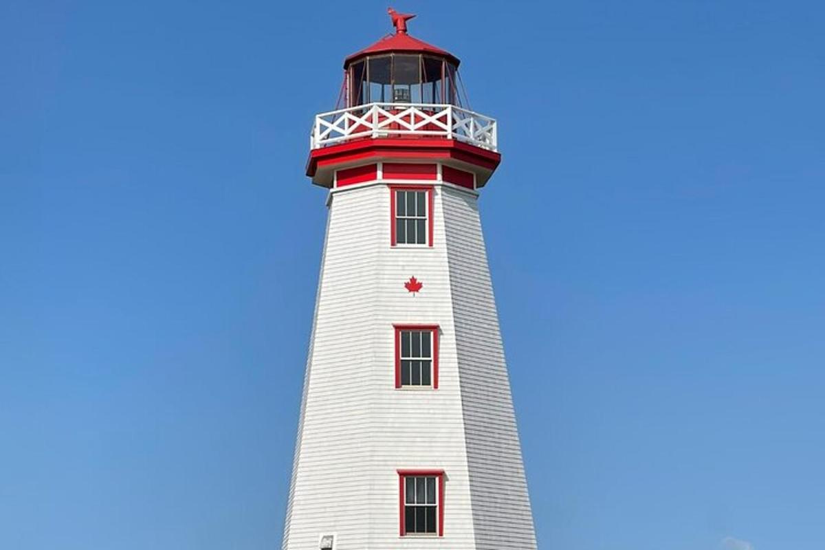 a red and white lighthouse with a blue sky