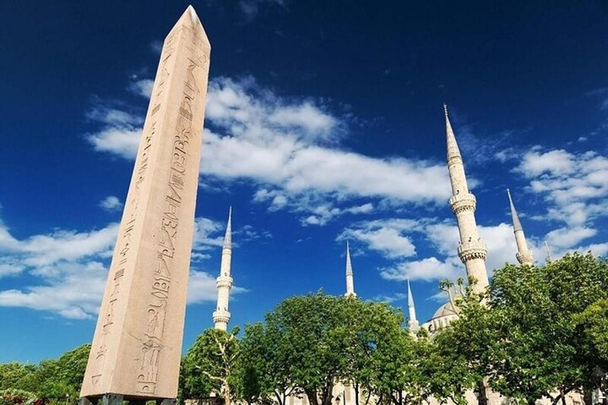 a tall monument in front of a building with mosques