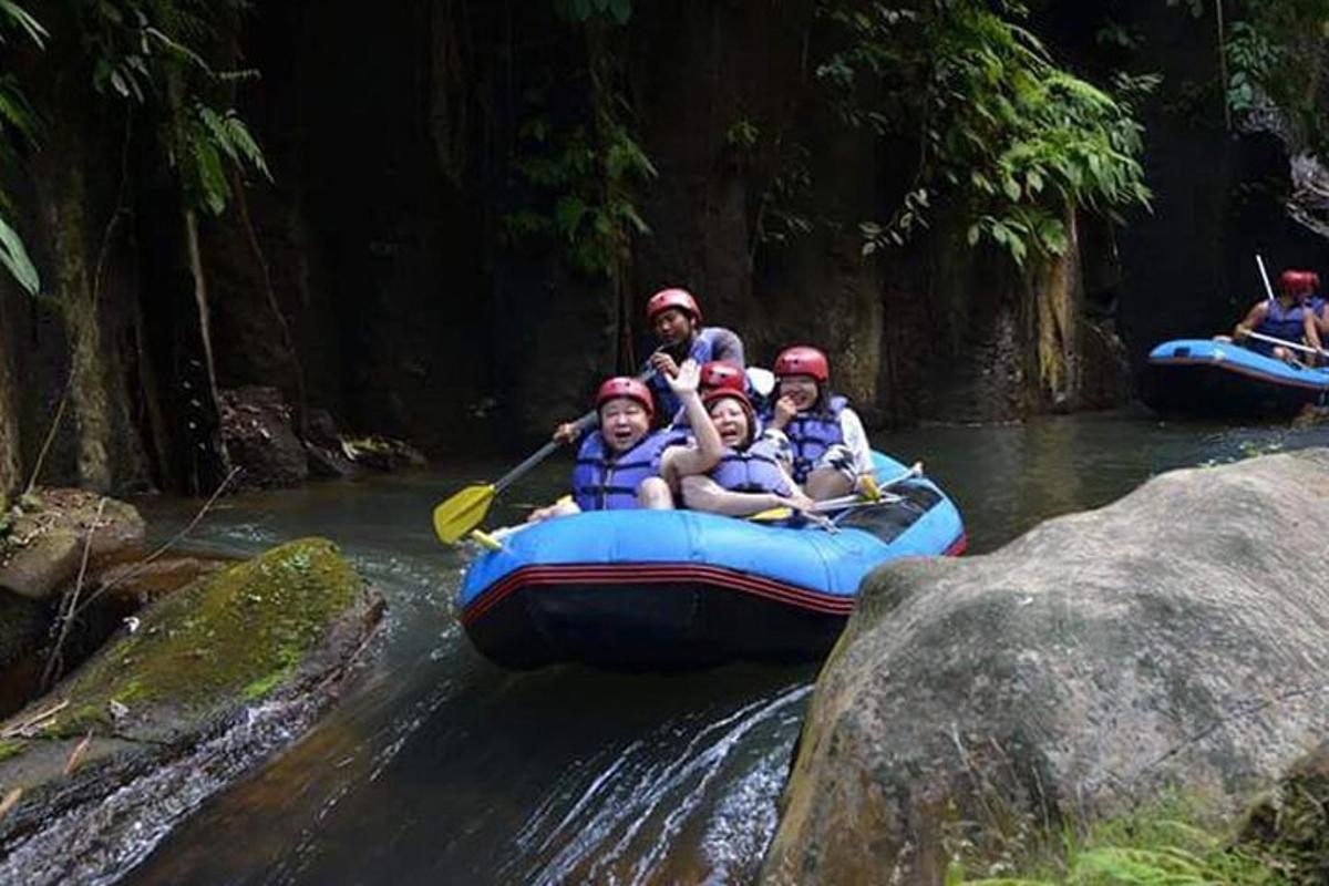 a group of people in a raft on a river