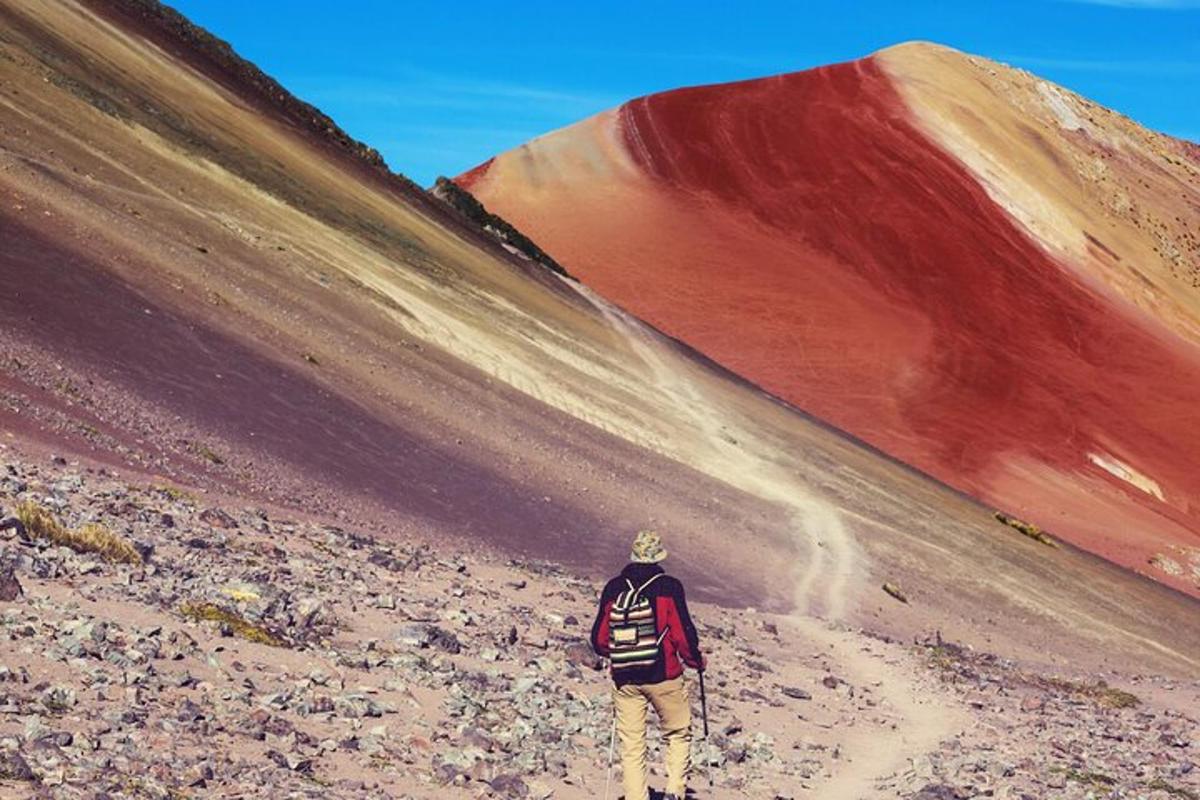 a man is walking up a dirt hill