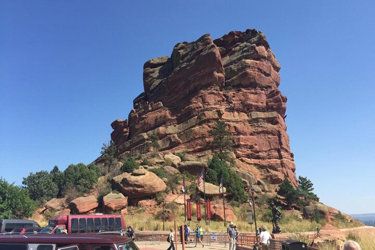a group of people standing in front of a mountain
