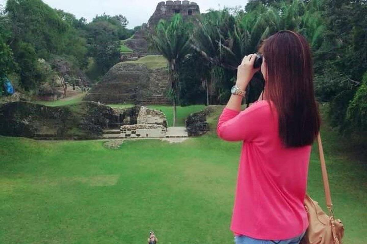 a woman taking a picture of the ruins