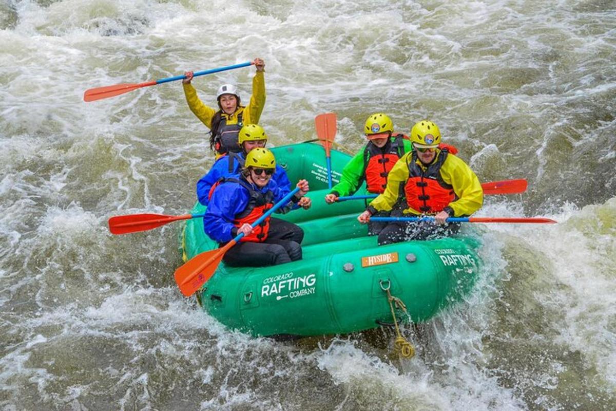 a group of people in a raft in the water