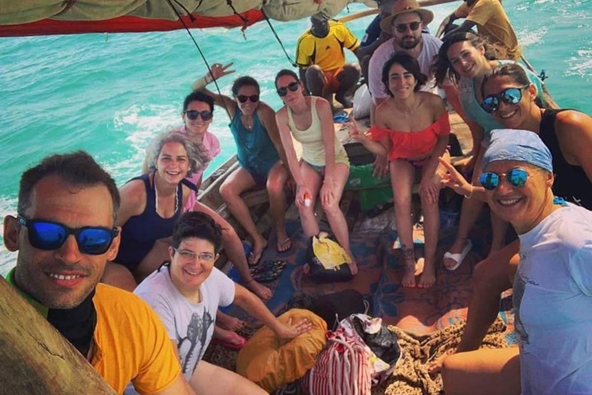 a group of people sitting on a boat in the water