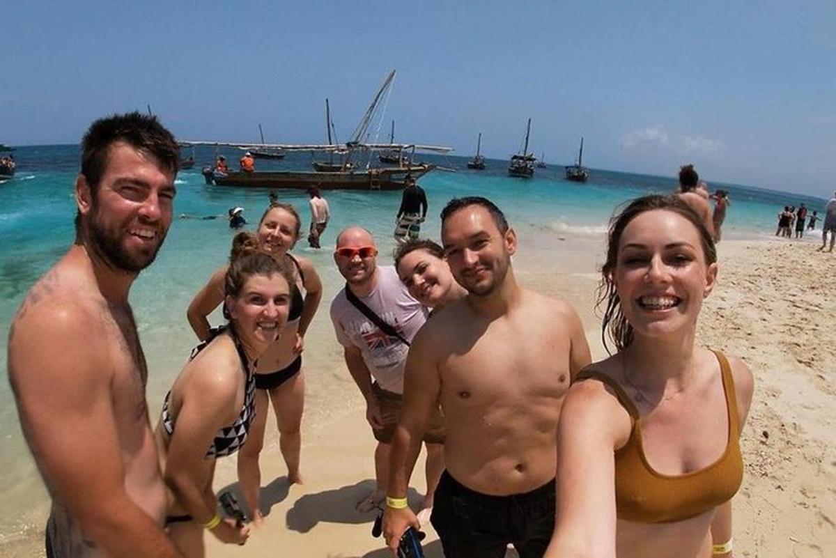 a group of people standing on the beach