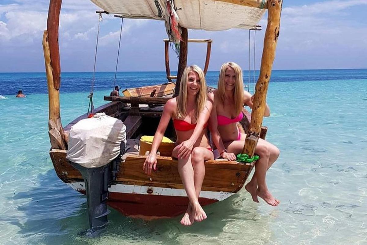 two women sitting on a boat in the ocean