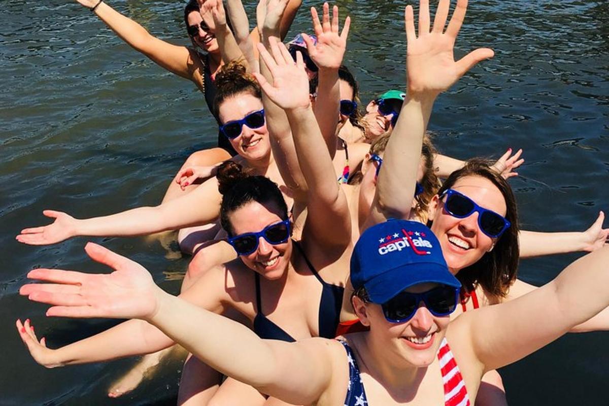 a group of women in the water waving