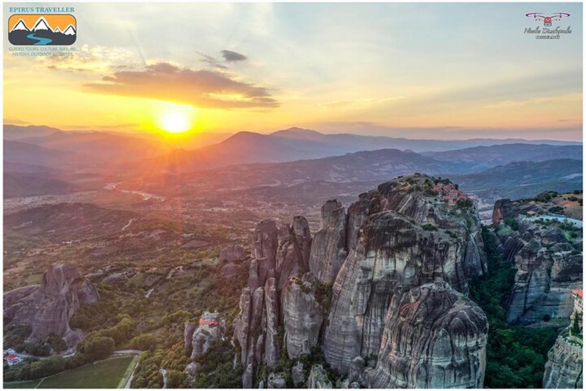 a view of a mountain with the sun setting