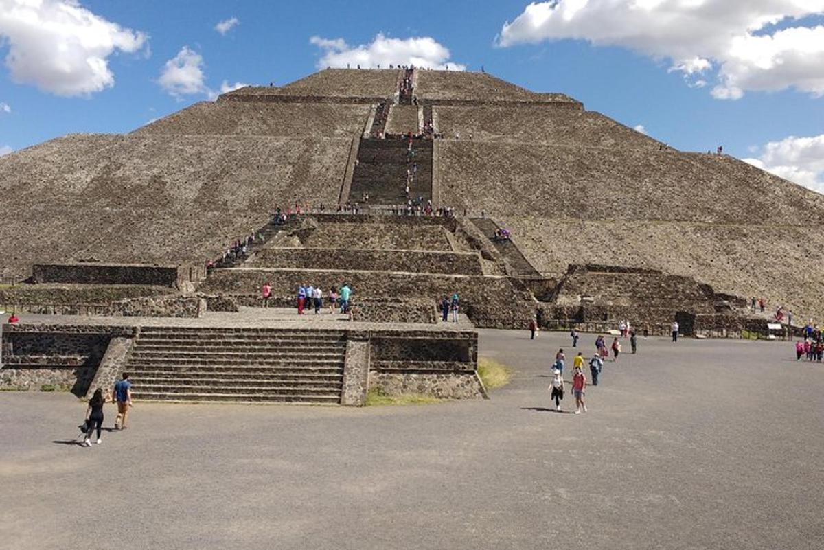 a pyramid with a group of people walking around it