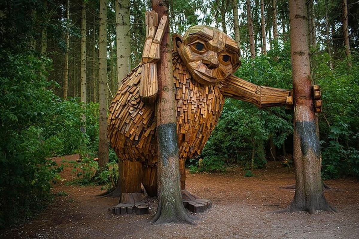 en statue av en bjørn som står i skogen