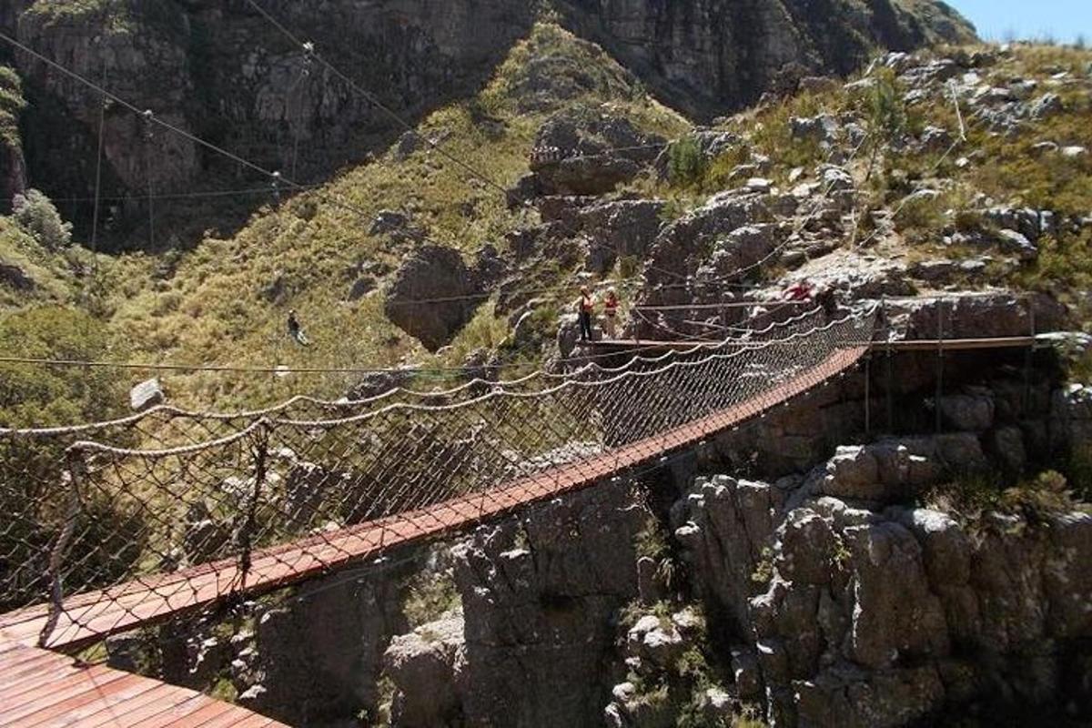 a suspension bridge on the side of a mountain