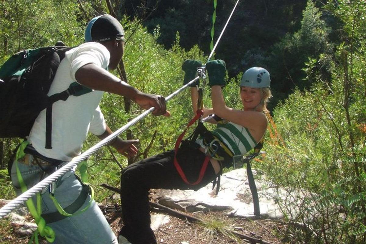 a woman on a zip line with a man
