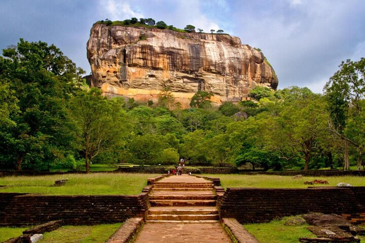 a staircase leading up to a large rock formation