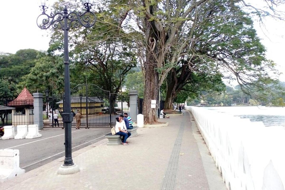 a couple of people sitting on a bench near the water