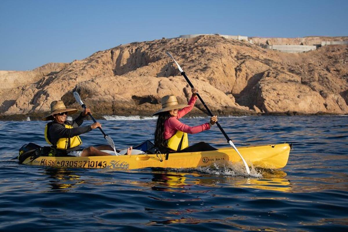 two people in a yellow kayak in the water
