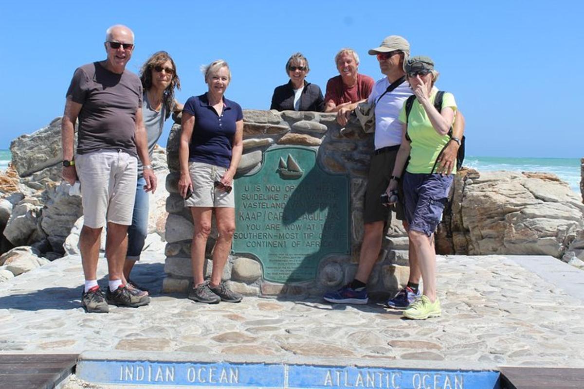 a group of people standing in front of a sign