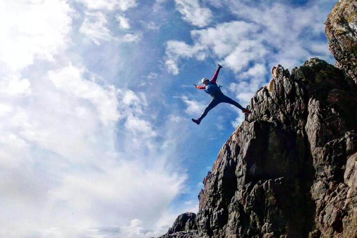 seorang lelaki sedang melompat dari gunung