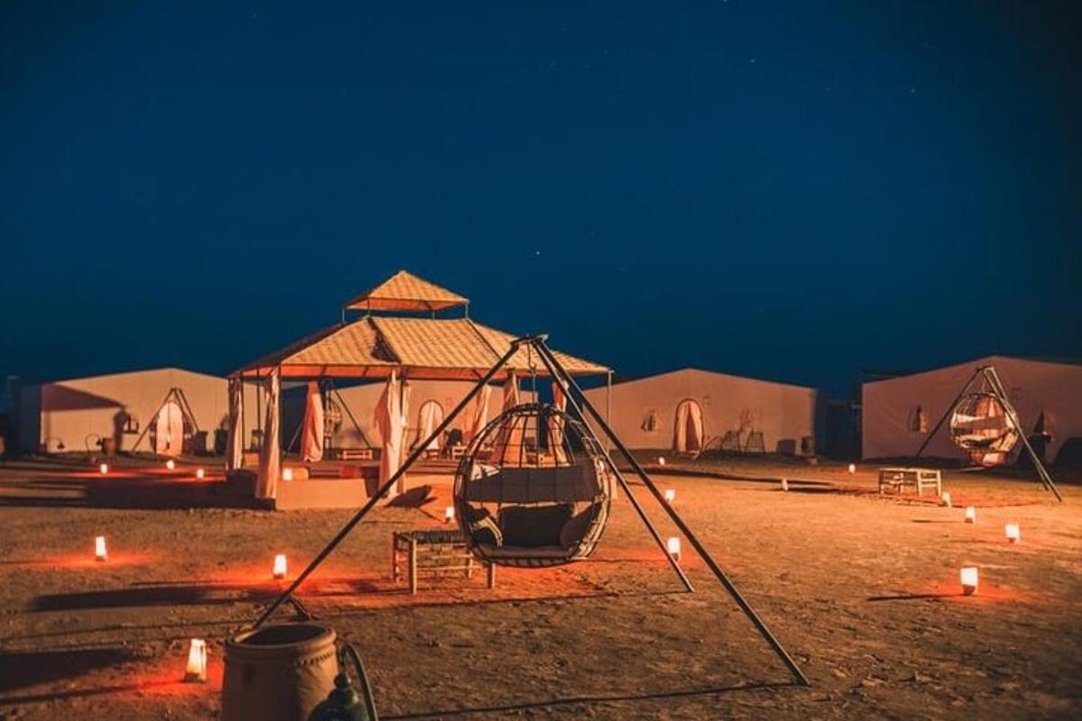 a swing in front of a tent with lit candles