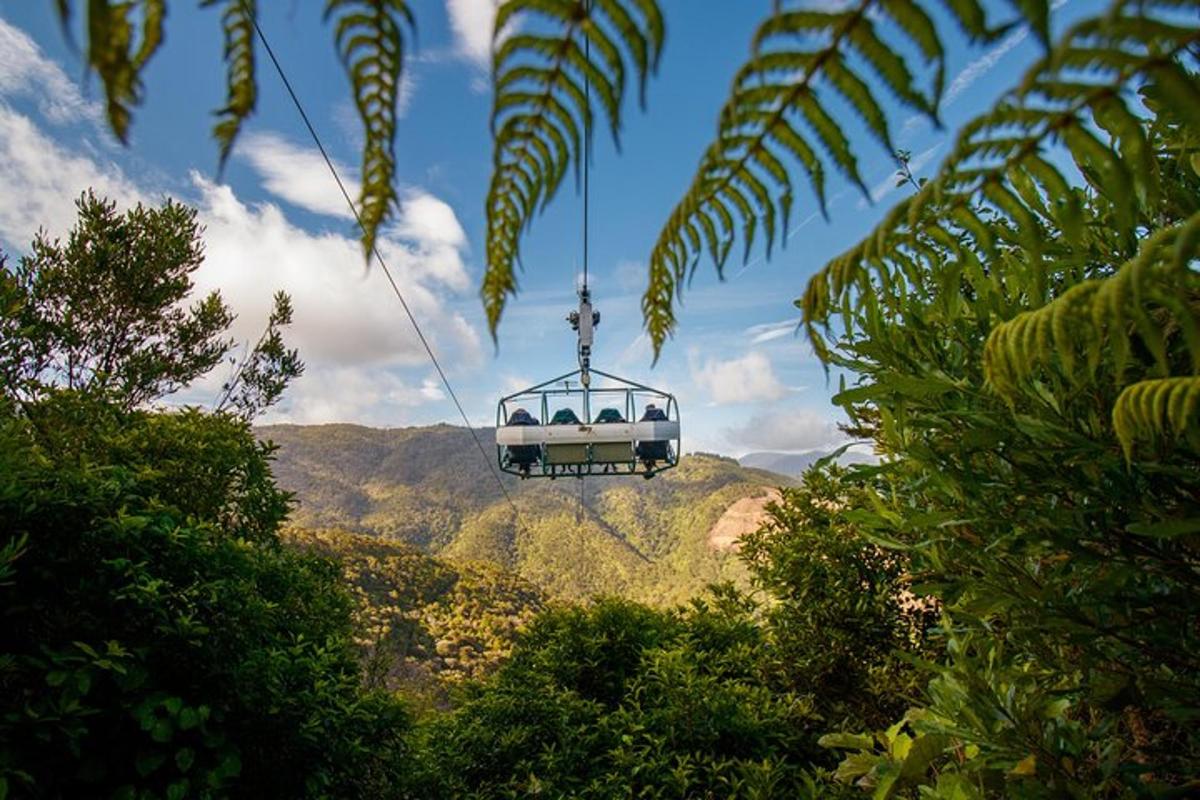 a gondola is suspended in the air over the mountains